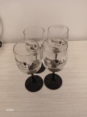 Eight wine glasses and two metal tabletop wine racks