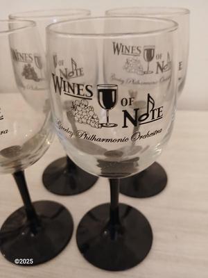 Eight wine glasses and two metal tabletop wine racks