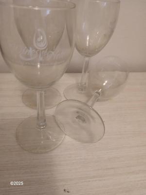 Eight wine glasses and two metal tabletop wine racks