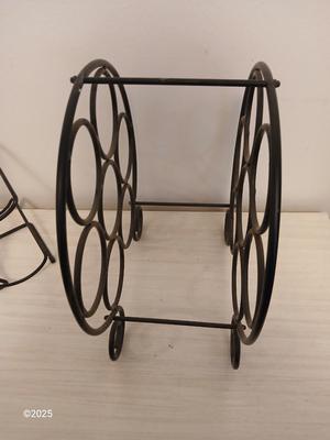 Eight wine glasses and two metal tabletop wine racks