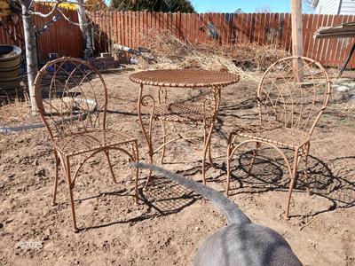 Metal bistro table with two chairs