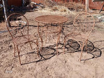 Metal bistro table with two chairs