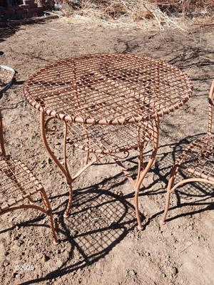 Metal bistro table with two chairs