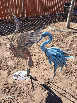 Two metal yard art birds
