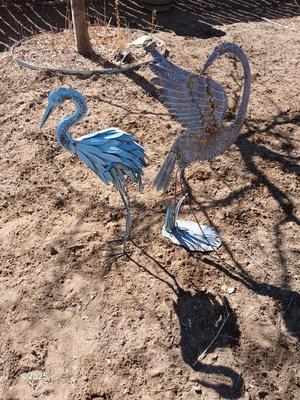 Two metal yard art birds