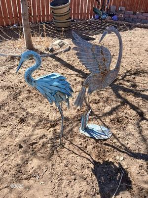 Two metal yard art birds