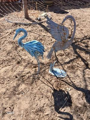 Two metal yard art birds