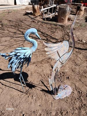 Two metal yard art birds
