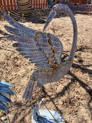 Two metal yard art birds