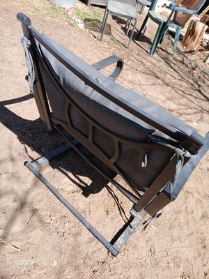 Two metal patio chairs with cushions