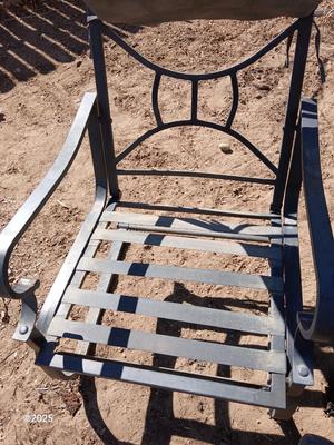 Two metal patio chairs with cushions