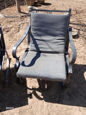 Two metal patio chairs with cushions