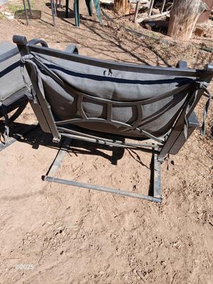 Two metal patio chairs with cushions