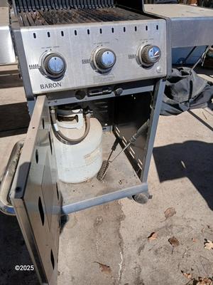 Duraflame Broil King Chrome BBQ grill with propane bottle