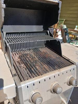 Duraflame Broil King Chrome BBQ grill with propane bottle