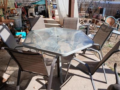 HUGE patio table with leaf imprint design on glass, 6 patio chairs and an umbrella stand
