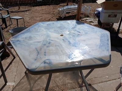 HUGE patio table with leaf imprint design on glass, 6 patio chairs and an umbrella stand