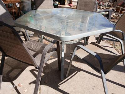 HUGE patio table with leaf imprint design on glass, 6 patio chairs and an umbrella stand