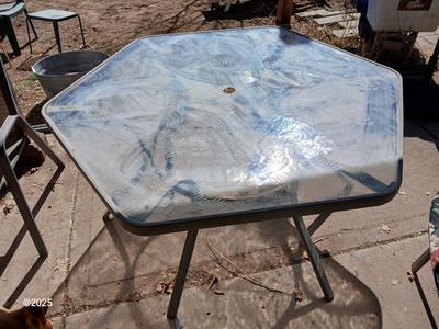 HUGE patio table with leaf imprint design on glass, 6 patio chairs and an umbrella stand