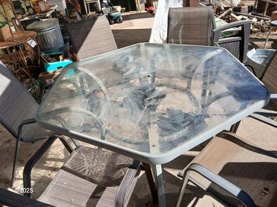HUGE patio table with leaf imprint design on glass, 6 patio chairs and an umbrella stand