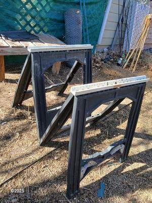Two portable folding plastic saw horses