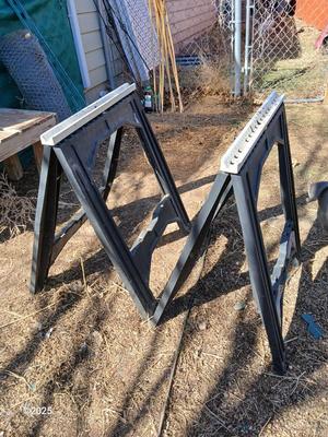 Two portable folding plastic saw horses