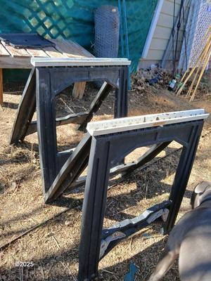 Two portable folding plastic saw horses