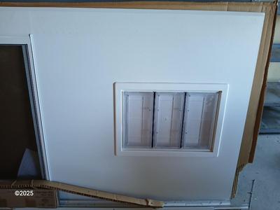 Brand new never installed EMCO K900 Series Storm door with Large pet entry system 36" x 80"