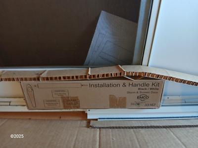Brand new never installed EMCO K900 Series Storm door with Large pet entry system 36" x 80"