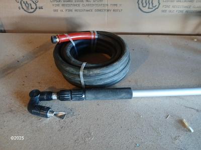 Brand new 25-foot garden hose with gutter cleaning attachment
