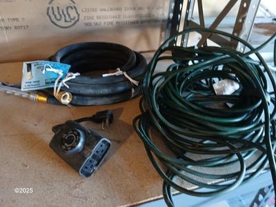 New 25-foot garden hose with spray attachment and two extension cords and timer