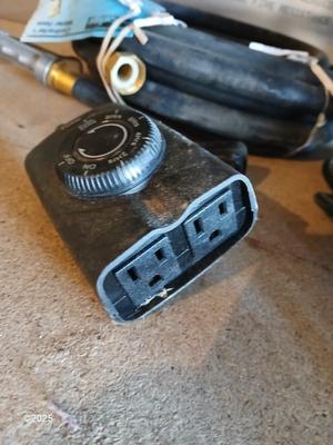 New 25-foot garden hose with spray attachment and two extension cords and timer