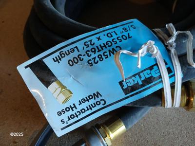New 25-foot garden hose with spray attachment and two extension cords and timer