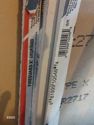 Four sheets of Fireguard X Gypsum board / Drywall with a Stanley Panel carry tool