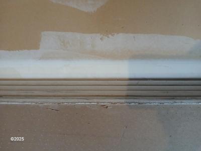 Four sheets of Fireguard X Gypsum board / Drywall with a Stanley Panel carry tool