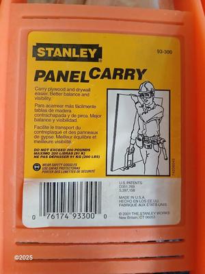 Four sheets of Fireguard X Gypsum board / Drywall with a Stanley Panel carry tool