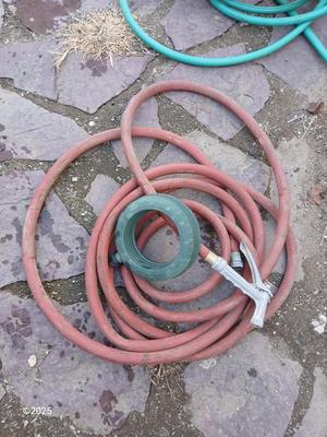 Two garden hoses with a sprinkler