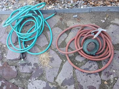 Two garden hoses with a sprinkler