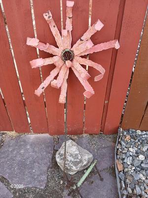 Handmade metal flower and stick horse made from rebar