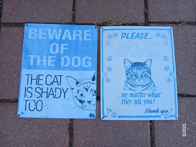 Two light metal / tin humorous signs
