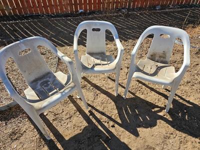 Three plastic patio chairs