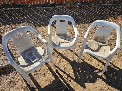 Three plastic patio chairs