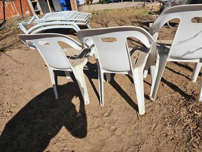 Three plastic patio chairs