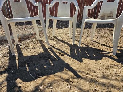 Three plastic patio chairs