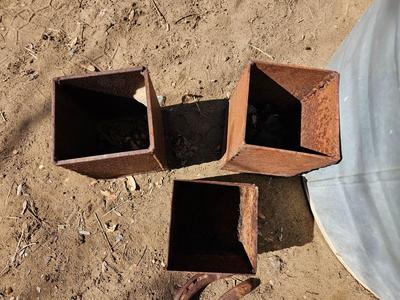 Galvanized tub with an assortment of horseshoes and metal boxes and an old can crsher