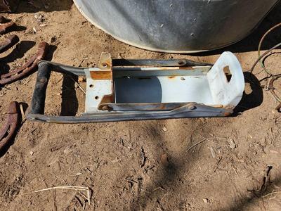 Galvanized tub with an assortment of horseshoes and metal boxes and an old can crsher