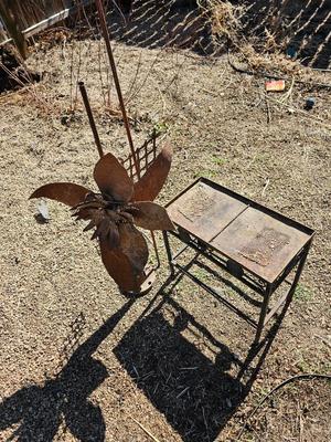Rustic yard / garden art flower with small rusty table - and a shepherd's hook plant hanger
