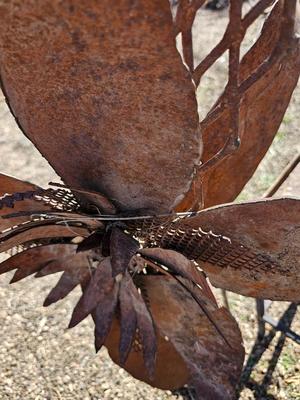 Rustic yard / garden art flower with small rusty table - and a shepherd's hook plant hanger