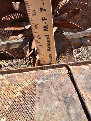 Rustic yard / garden art flower with small rusty table - and a shepherd's hook plant hanger