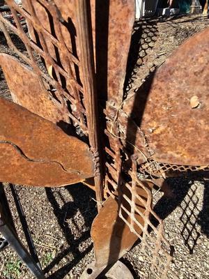 Rustic yard / garden art flower with small rusty table - and a shepherd's hook plant hanger